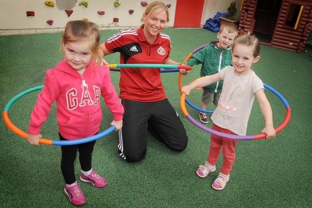 Toddlers at Cleadon Village Kindergarten, Erin Caldor- Crone, Thomas Degnan and Eve Pearson taking part in their sports day with the help of Sunderland Women's footballer, Gemma Wilson in 2013.