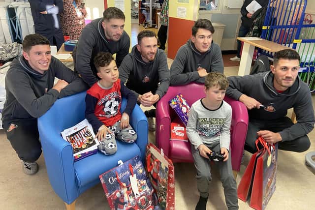 Sunderland players (left to right) Ross Stewart, Lynden Gooch, Corry Evans, Luke O'Nien and Danny Batth with children Deacon Harland, nine, and Alex McNicoll, eight. 

Picture by FRANK REID