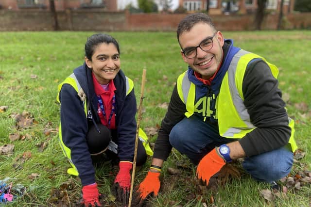 East Rangers Members Reema Reddiar and Yassine Amrani plant a tree sapling at Backhouse Park, Sunderland.