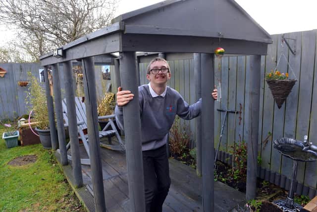 Hugh Clinton, 13, inside the giant Penshaw Monument model in his family's garden.