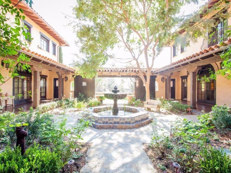 The property is accompanied by numerous dramatic equestrian structures, water wells and seasonal running streams.