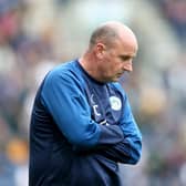 PRESTON, ENGLAND - AUGUST 10: Paul Cook manager of Wigan Athletic stands dejected during the Sky Bet Championship match between Preston North End and Wigan Athletic at Deepdale on August 10, 2019 in Preston, England. (Photo by Lewis Storey/Getty Images)