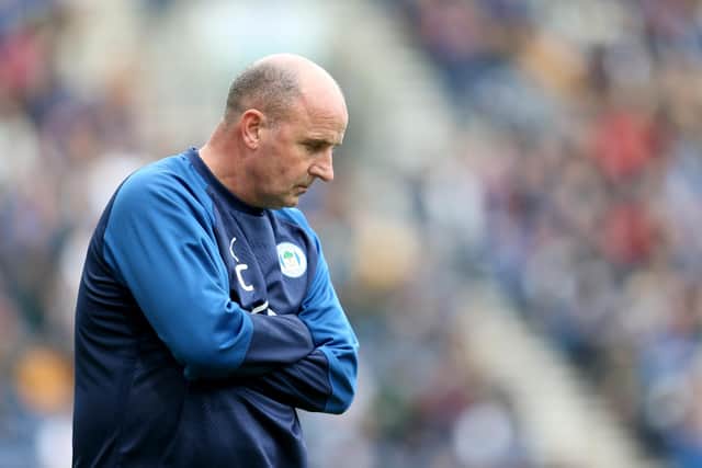 PRESTON, ENGLAND - AUGUST 10: Paul Cook manager of Wigan Athletic stands dejected during the Sky Bet Championship match between Preston North End and Wigan Athletic at Deepdale on August 10, 2019 in Preston, England. (Photo by Lewis Storey/Getty Images)