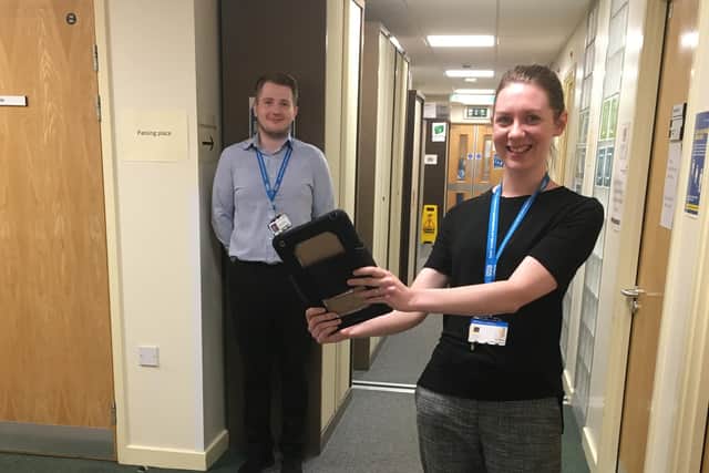 Speech and Language Therapist Caroline Ewers and IT Infrastructure Technician Sean Hutchinson used an iPad to help the family share some exciting news.