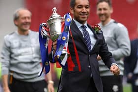 GLASGOW, SCOTLAND - MAY 21: Rangers manager Giovanni van Bronckhorst holds the trophy after his team defeat Hearts 2-0 after extra time during the Scottish Cup Final match between Rangers and Heart of Midlothian at Hampden Park on May 21, 2022 in Glasgow, Scotland. (Photo by Ian MacNicol/Getty Images)
