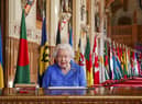 Queen Elizabeth II signs her annual Commonwealth Day Message in St George's Hall at Windsor Castle.