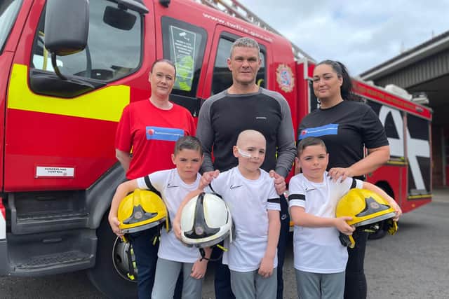 Crew Manager Peter Wilson with triplets Oscar, Oliver and Owen at Sunderland Central Community Fire Station with Lynn Murphy and Gemma Lowery of the Bradley Lowery Foundation.