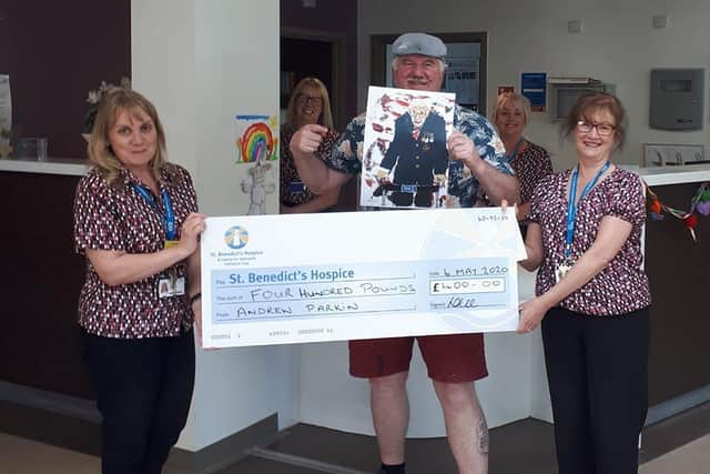 Andy Parkin donating a cheque to St Benedict's Hospice