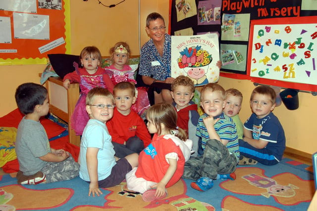 Librarian Sue Roberts had the attention of these children during a book reading at the Fingerpaint Kindergarten in 2009.