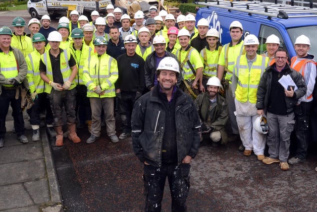 DIY SOS presenter Nick Knowles (front centre) with some of his team of builders and local tradesmen who were helping to rebuild a house in Houghton-le-Soring in 2013. He was in series 18 of I'm A Celebrity.