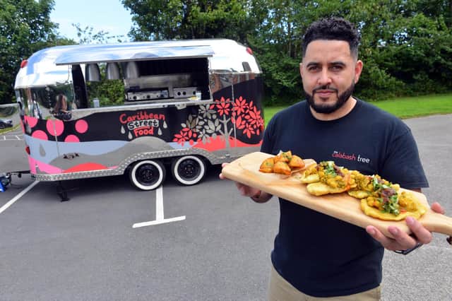 The Calabash Tree owner Ryan McVay with Trinidadian inspired food from his mobile trailer