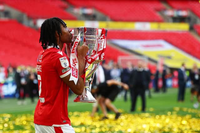LONDON, ENGLAND - MAY 29: Djed Spence of Nottingham Forest kisses the trophy following their sides victory in the Sky Bet Championship Play-Off Final match between Huddersfield Town and Nottingham Forest at Wembley Stadium on May 29, 2022 in London, England. (Photo by Christopher Lee/Getty Images)