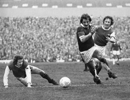 Arsenal's Liam Brady watches, unable to reach the ball, as team mate George Armstrong  (1944 - 2000) races after Leicester City's Frank Worthington, during their FA Cup fifth round tie at Highbury.  (Photo by Central Press/Getty Images)