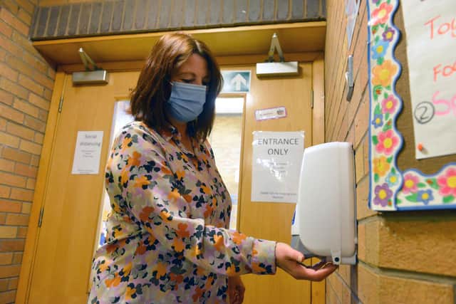 Fatfield Academy headteacher Tracey Pizl uses a sanitiser station inside the school.