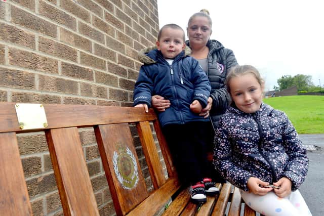 Bage Walker, sister of war hero Richard Walker at his memorial bench with her children Rayne, two and Lexi seven. Image, Sunderland Echo.