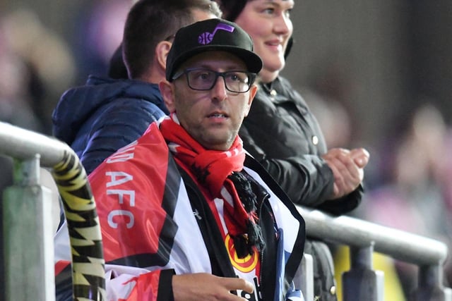 A replica shirt, scarf and a flag is the outfit of the day for this fan