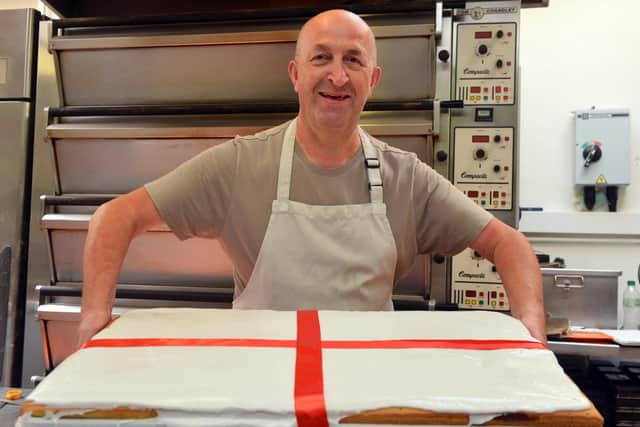 Muller's bakers owner Max Muller with the St George's Cross pink slice slab  ahead of the EURO England V Italy final.