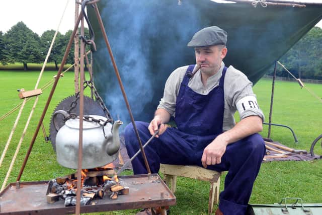A member of the Land Army making a cup of tea.