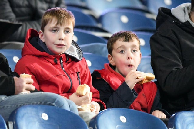 Two young Sunderland supporters are captured grabbing a quick bite to eat