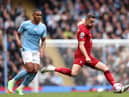 MANCHESTER, ENGLAND - APRIL 01: Jordan Henderson of Liverpool is challenged by Manuel Akanji of Manchester City during the Premier League match between Manchester City and Liverpool FC at Etihad Stadium on April 01, 2023 in Manchester, England. (Photo by Clive Brunskill/Getty Images)