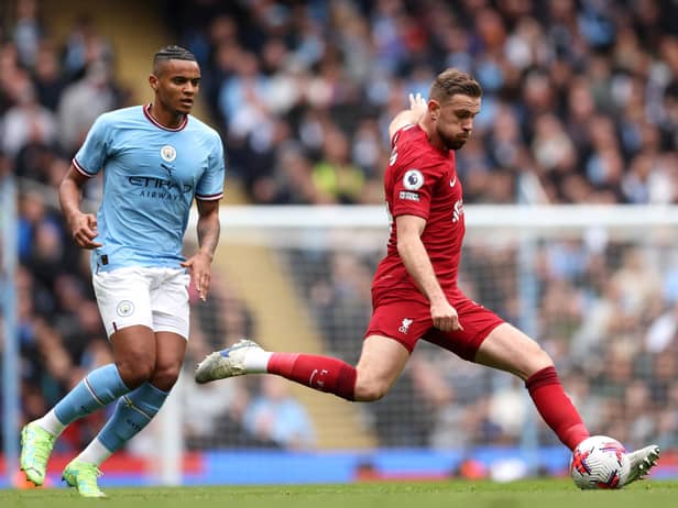 MANCHESTER, ENGLAND - APRIL 01: Jordan Henderson of Liverpool is challenged by Manuel Akanji of Manchester City during the Premier League match between Manchester City and Liverpool FC at Etihad Stadium on April 01, 2023 in Manchester, England. (Photo by Clive Brunskill/Getty Images)