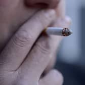 A man smoking a cigarette.