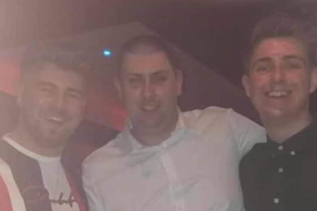 Aidan, 23, (right) with twin Andrew (left) and brother Craig (middle)