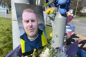 A photograph, flowers and cards on the roundabout near to where Lee Stevenson died following a road traffic collision on March 25.