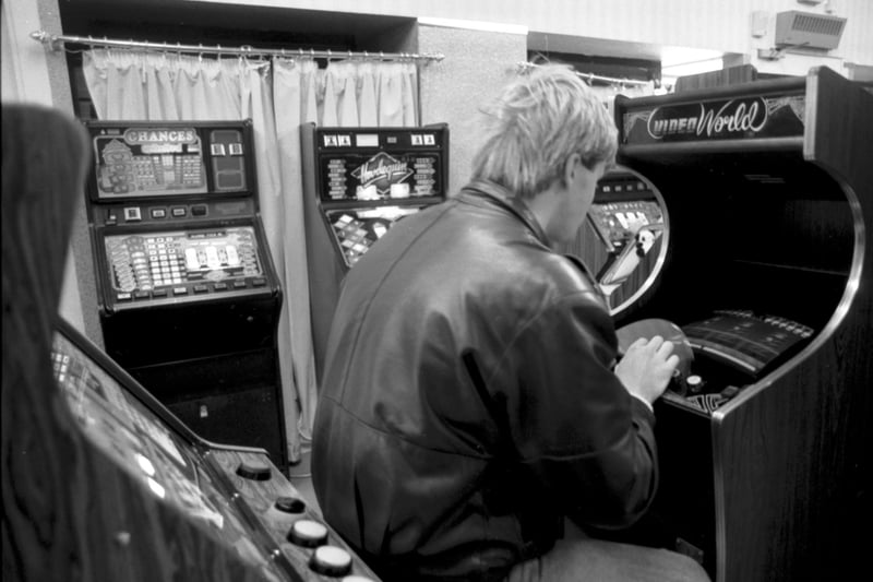 A man playing on a Space Invaders-type machine in an Edinburgh video arcade in September 1986.
