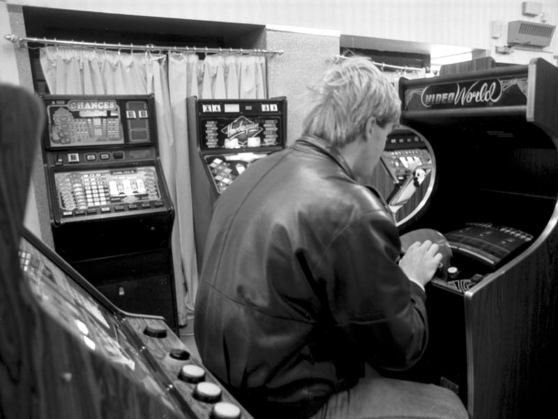 A man playing on a Space Invaders-type machine in an Edinburgh video arcade in September 1986.