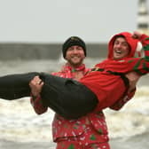 Jonny Davies braves the North Sea in the arms of his friend Steven Rutter.
