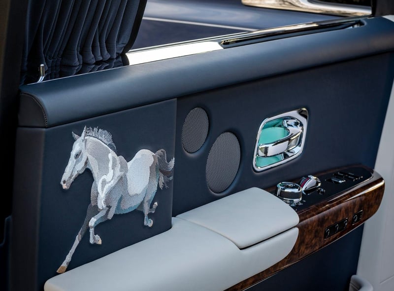 CANVAS: PHANTOM EXTENDED │MEDIUM: EMBROIDERY
Complex Bespoke embroideries of a stallion embellish the interior rear doors of this elegant Phantom Extended. Signifying strength and an unremitting enthusiasm to progress, the embroidery of the steed was developed from a sketch, presented to the Rolls-Royce Bespoke Design Collective, by a Chinese client with a very clear vision.