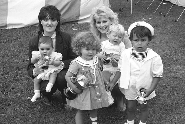 Claire Louise Richardson (centre) clutching the trophy she won as bonniest baby in the Echo/Sunderland Recreation Ground show.  She is surrounded by the winners of the other sections, Graham Smith, of Town End Farm, with his mother; Stephen Watson of Roker, with his  mother;  and extreme right Ryan Nell, of Ford Estate.