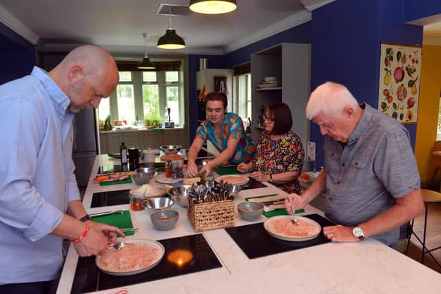 Guests taking part in free cookery lessons in Life Kitchen in Mowbray Park