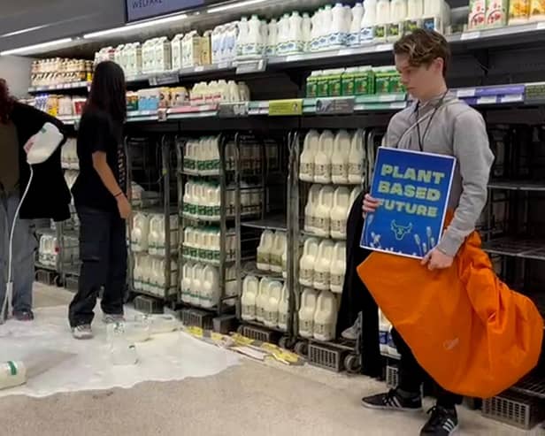Handout photo issued by Animal Rebellion of supporters of Animal Rebellion pouring out milk in a Waitrose in Edinburgh. Issue date: Saturday October 15, 2022.