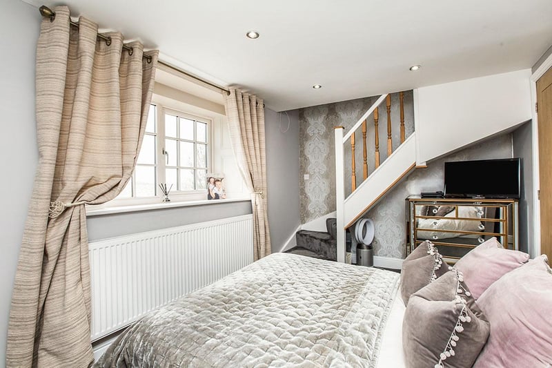 A double bedroom with built-in wardrobes, an ensuite shower room and stairs to a mezzanine dressing room.