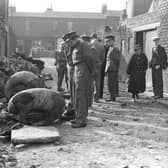 Locals inspect the wheels of a German bomber which crashed in a back lane at Suffolk Street after an air raid in September 1940.