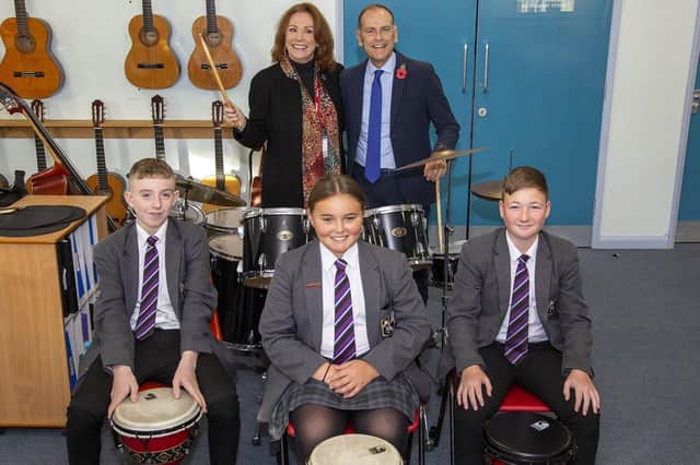 Melanie Hill and Jeff Brown help the students out in a drumming lesson.