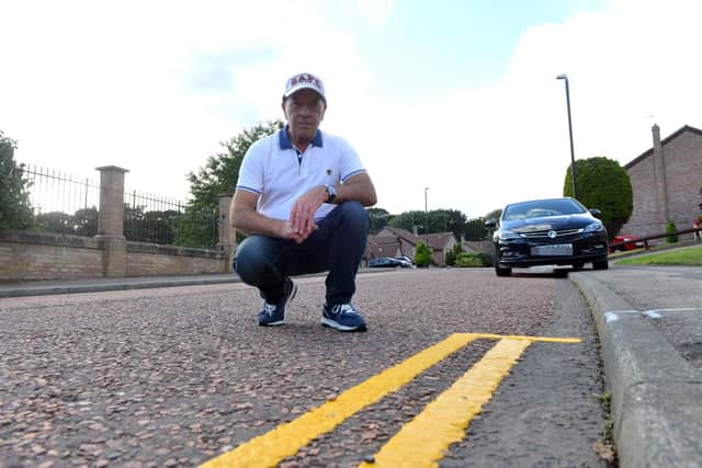 Seafields resident Ray Barker beside double yellow lines on the estate.