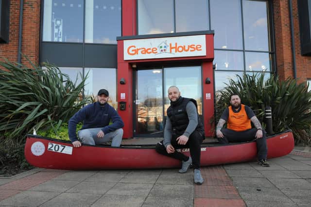 Shaun Armbruster, 32, Ryan Gallagher, 34, and Danny Bell, 28, with their canoe, which they will carry whilst running Hadrian's Wall to raise money for Grace House.
