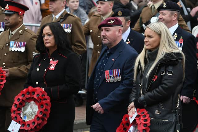 Carla and Tom Cuthbertson (centre) wait to lay their wreath