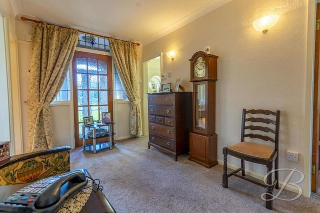 Moving on to the dining room, which is a delightful space with a touch of elegance. It features a carpeted floor and central heating radiator.