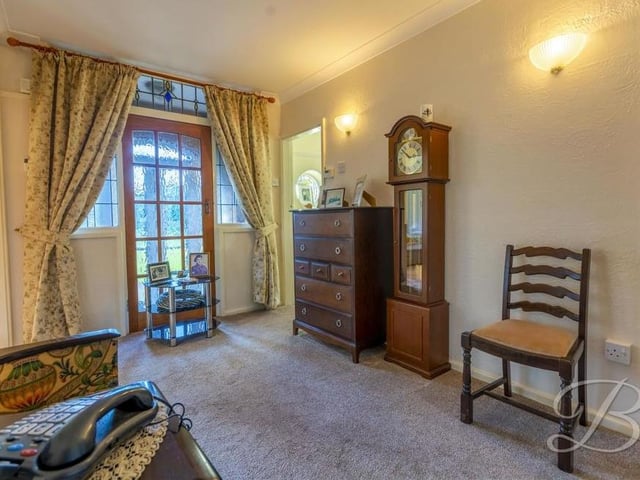 Moving on to the dining room, which is a delightful space with a touch of elegance. It features a carpeted floor and central heating radiator.