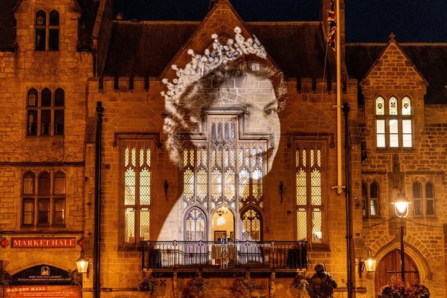 An image of Queen Elizabeth II on her coronation day in June 1953, is projected onto the Market Square in Durham.