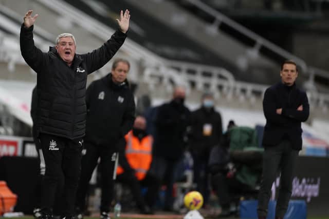 Newcastle United's English head coach Steve Bruce (L) reacts as Fulham's English manager Scott Parker (R) watches during the English Premier League football match between Newcastle United and Fulham at St James' Park in Newcastle-upon-Tyne, north east England on December 19, 2020.