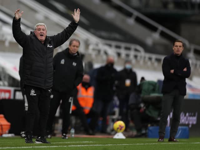 Newcastle United's English head coach Steve Bruce (L) reacts as Fulham's English manager Scott Parker (R) watches during the English Premier League football match between Newcastle United and Fulham at St James' Park in Newcastle-upon-Tyne, north east England on December 19, 2020.