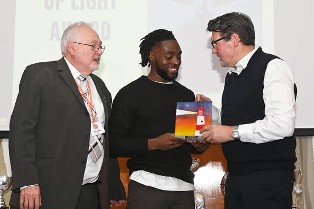 Fred Onyedinma is presented with the Beacon of Light award by former Sunderland AFC player Mick Harford

Photograph: Gareth Owen/LTFC