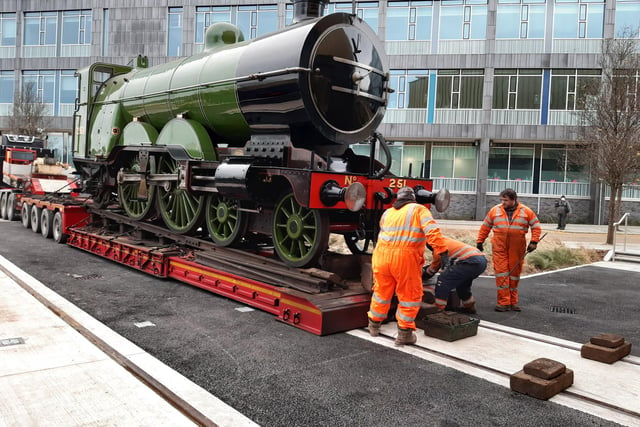 Workmen prepare to take engine number 251 off the lorry at Doncaster Museum, putting rails down