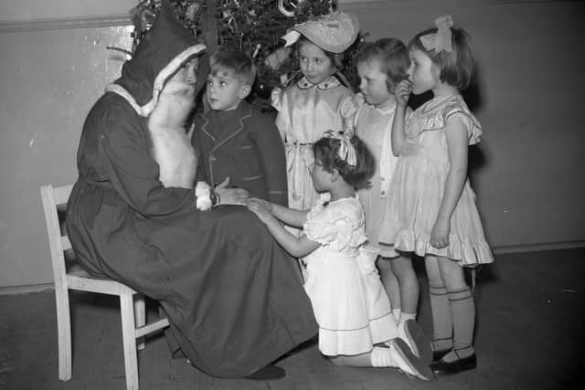 What did you ask Santa for? Here are children meeting Father Christmas in the Joplings store in 1952.