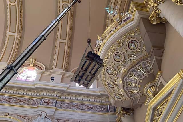 The organ is lifted into place in the Basilica.